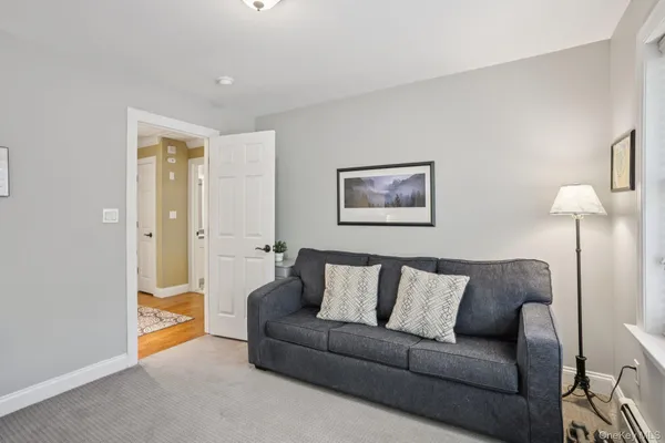 a living room with furniture and a lamp