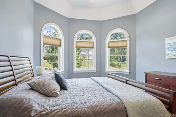a bedroom with a two beds and a large window