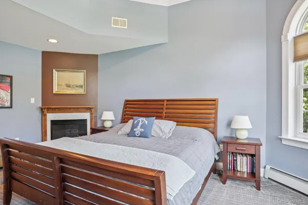 a bedroom with a bed and a fireplace