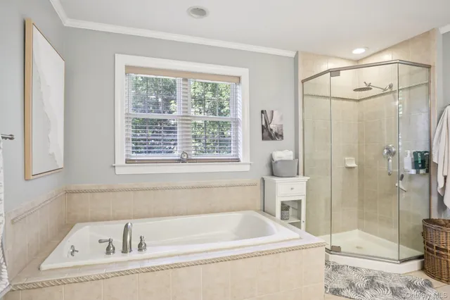 a bathroom with a tub and a shower