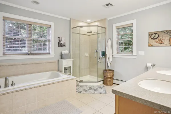 a spacious bathroom with sink shower and bathtub