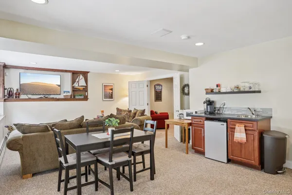 a dining hall with stainless steel appliances a stove a table and chairs