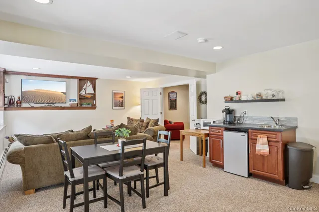 a dining hall with stainless steel appliances a stove a table and chairs
