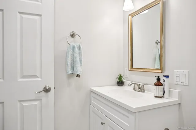 a bathroom with a sink vanity and a mirror