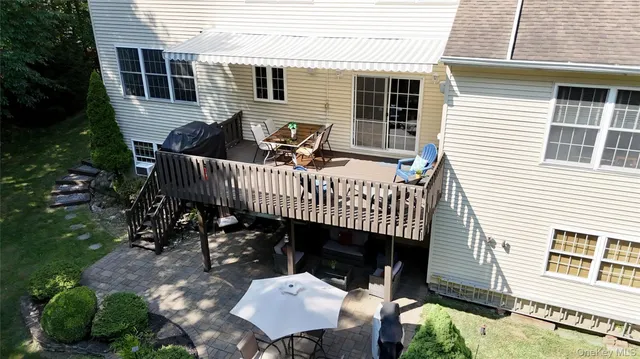 a view of a deck with furniture and a yard