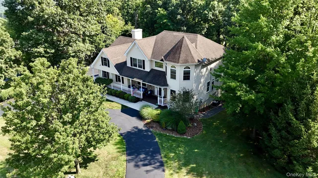 a view of a house with a yard and potted plants