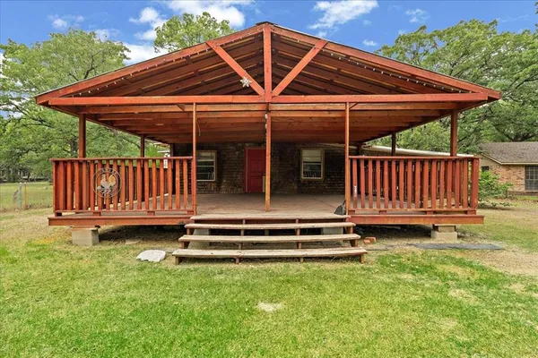 a backyard of a house with barbeque oven table and chairs
