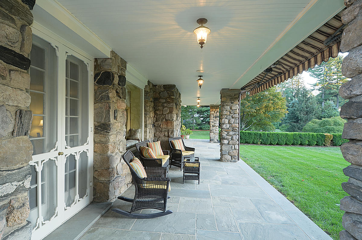 1081 Ponus Ridge Road New Canaan, CT 06840 - Photo 5 of 37 a view of a patio with dining table and chairs