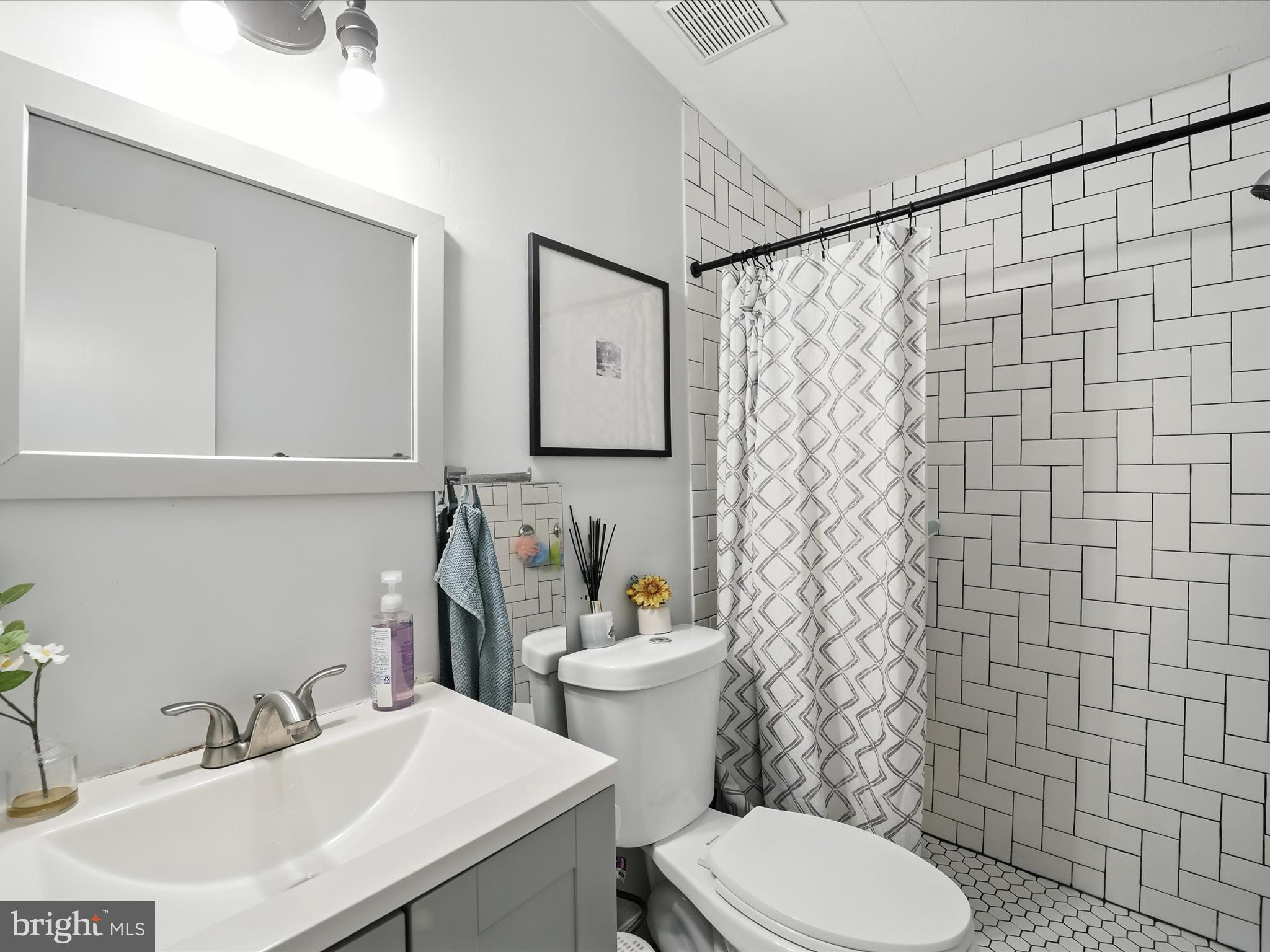 6 Patuxent Mobile Estates Lothian, MD 20711 - Photo 12 of 15 a bathroom with a sink a toilet and a mirror