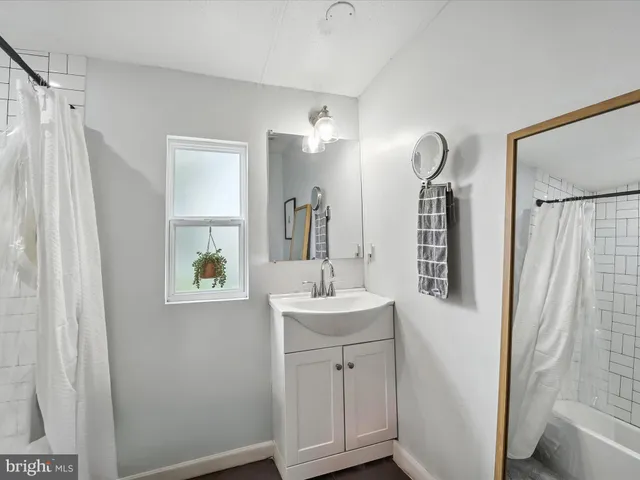 a bathroom with a sink a mirror and shower