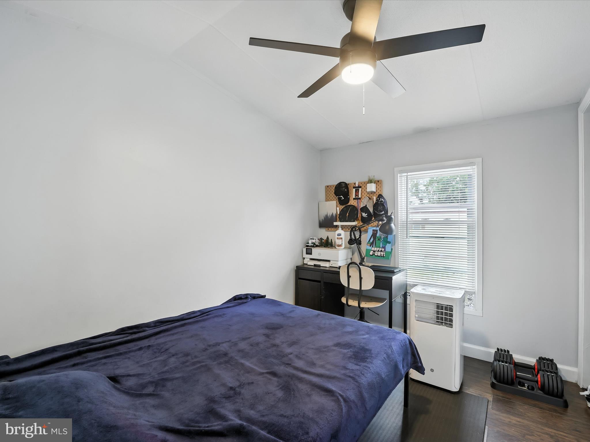 6 Patuxent Mobile Estates Lothian, MD 20711 - Photo 10 of 15 a bedroom with a bed and a chandelier