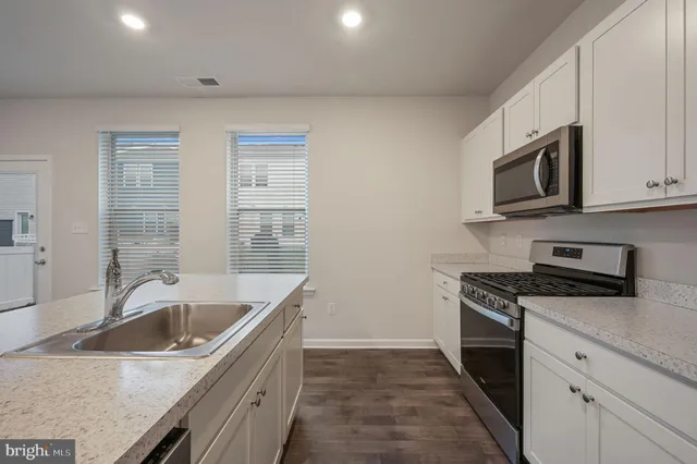a kitchen that has a sink and a stove