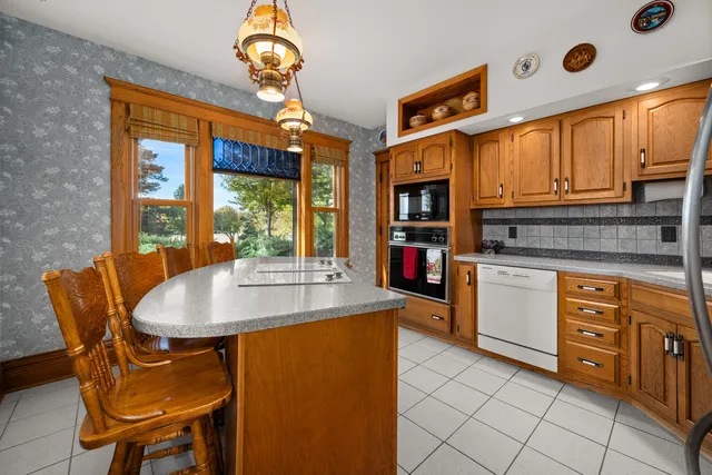 a living room with furniture a rug and a floor to ceiling window
