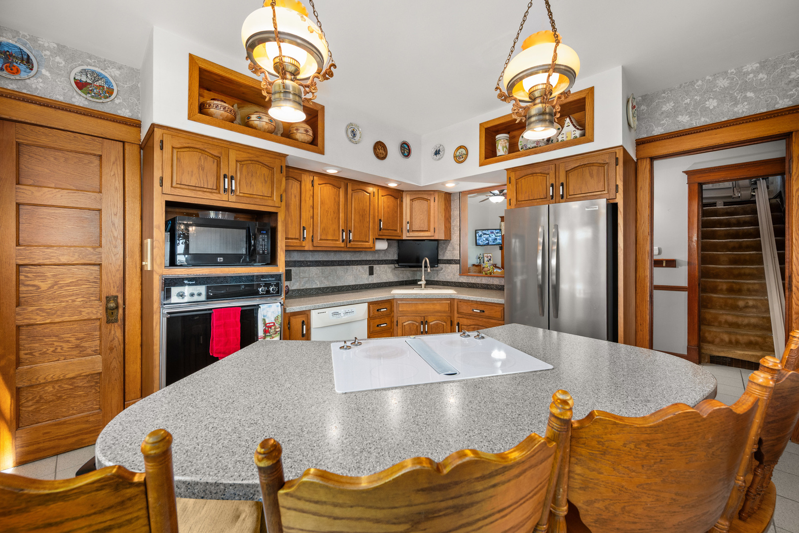 15165 Quigley Road Sycamore, IL 60178 - Photo 15 of 101 a kitchen with stainless steel appliances kitchen island granite countertop a refrigerator a stove and a sink with wooden floor