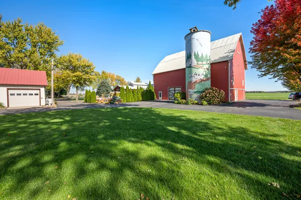 a view of yard with swimming pool and green space