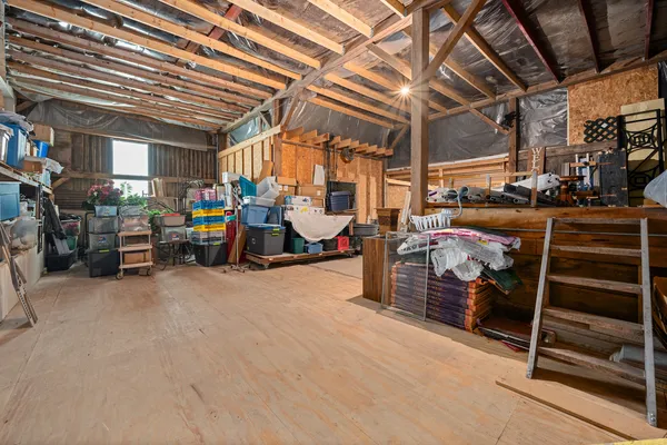 a view of a hallway with wooden floor and windows