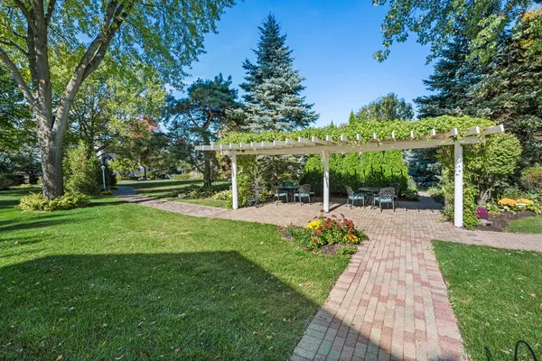 an aerial view of a house with a garden and lake view