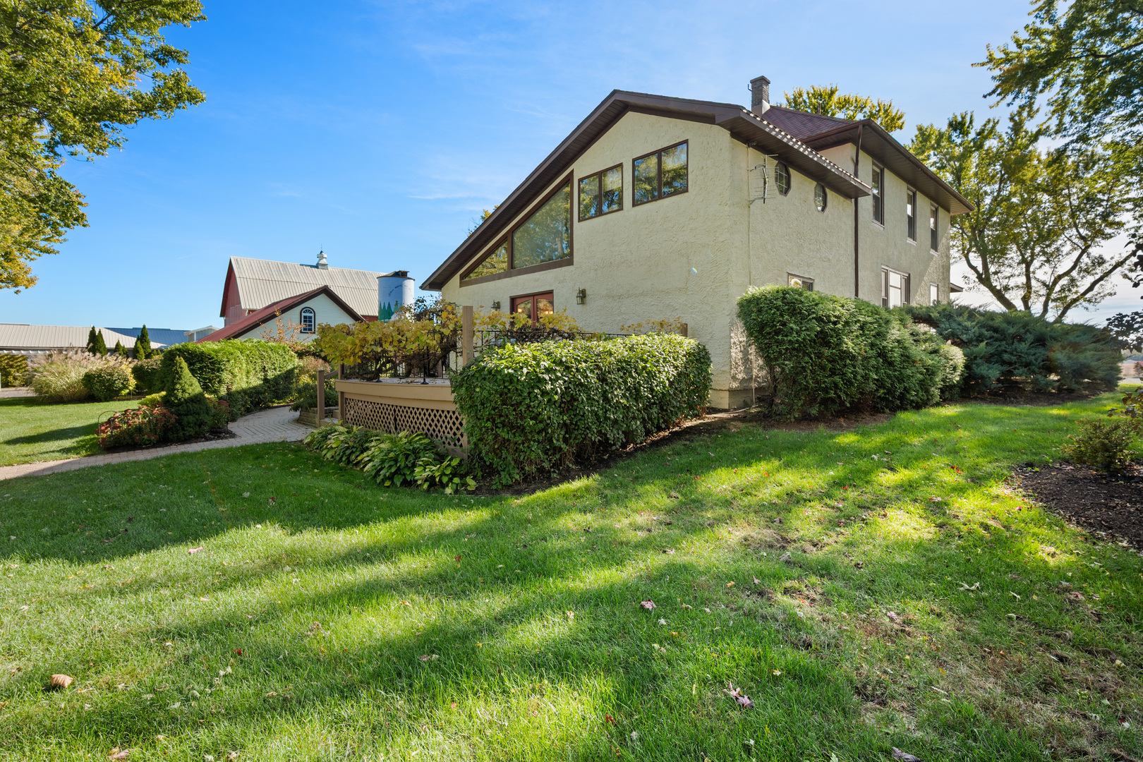 15165 Quigley Road Sycamore, IL 60178 - Photo 5 of 101 a view of a house with a small yard and plants