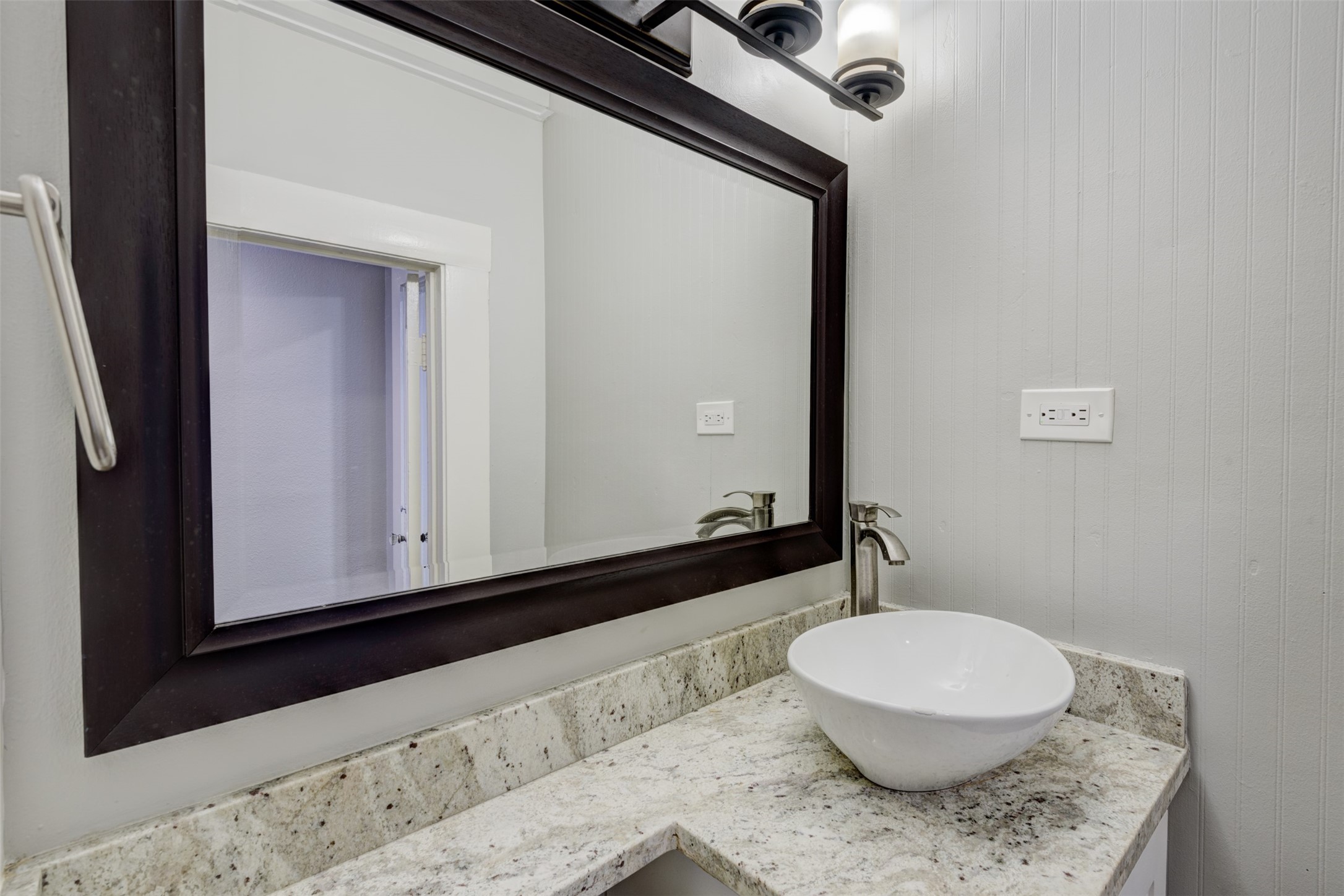 1313 Peden Street Houston, TX 77006 - Photo 11 of 33 a bathroom with a granite countertop sink and a mirror