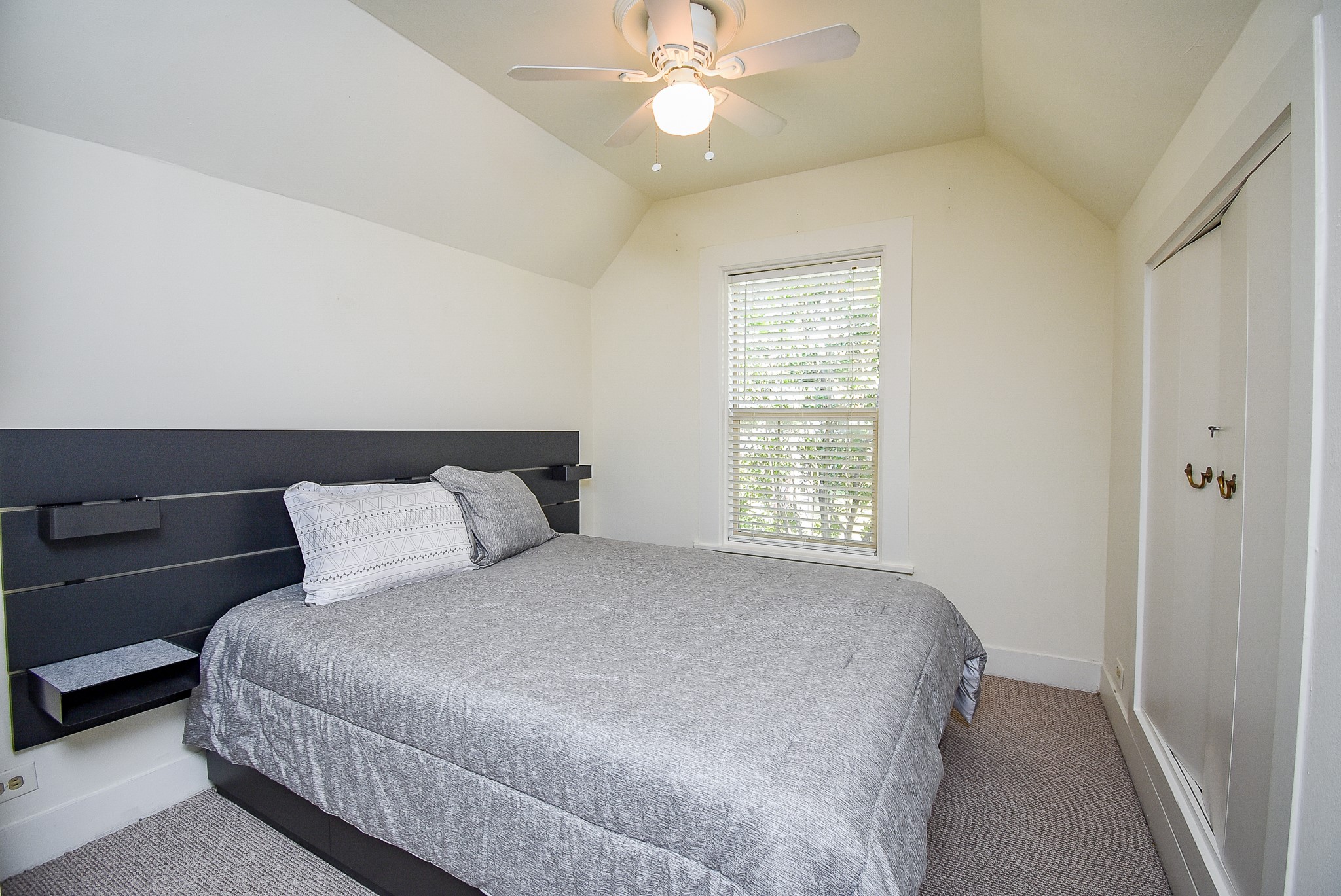 1313 Peden Street Houston, TX 77006 - Photo 15 of 33 a bedroom with a large bed and a chandelier