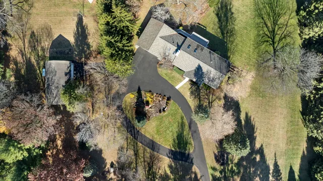 an aerial view of a house with a yard basket ball court and outdoor seating
