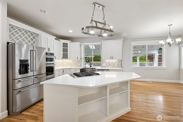 a kitchen with stainless steel appliances granite countertop a sink stove and refrigerator