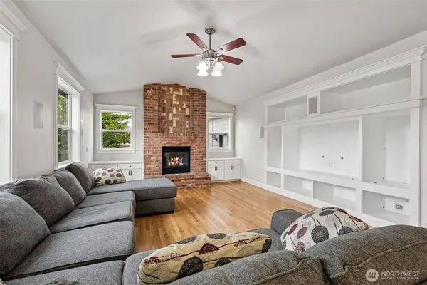 a living room with furniture a fireplace and a chandelier