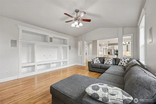 a living room with furniture and a wooden floor