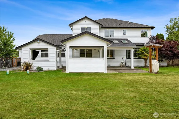 a view of a house with backyard and entertaining space