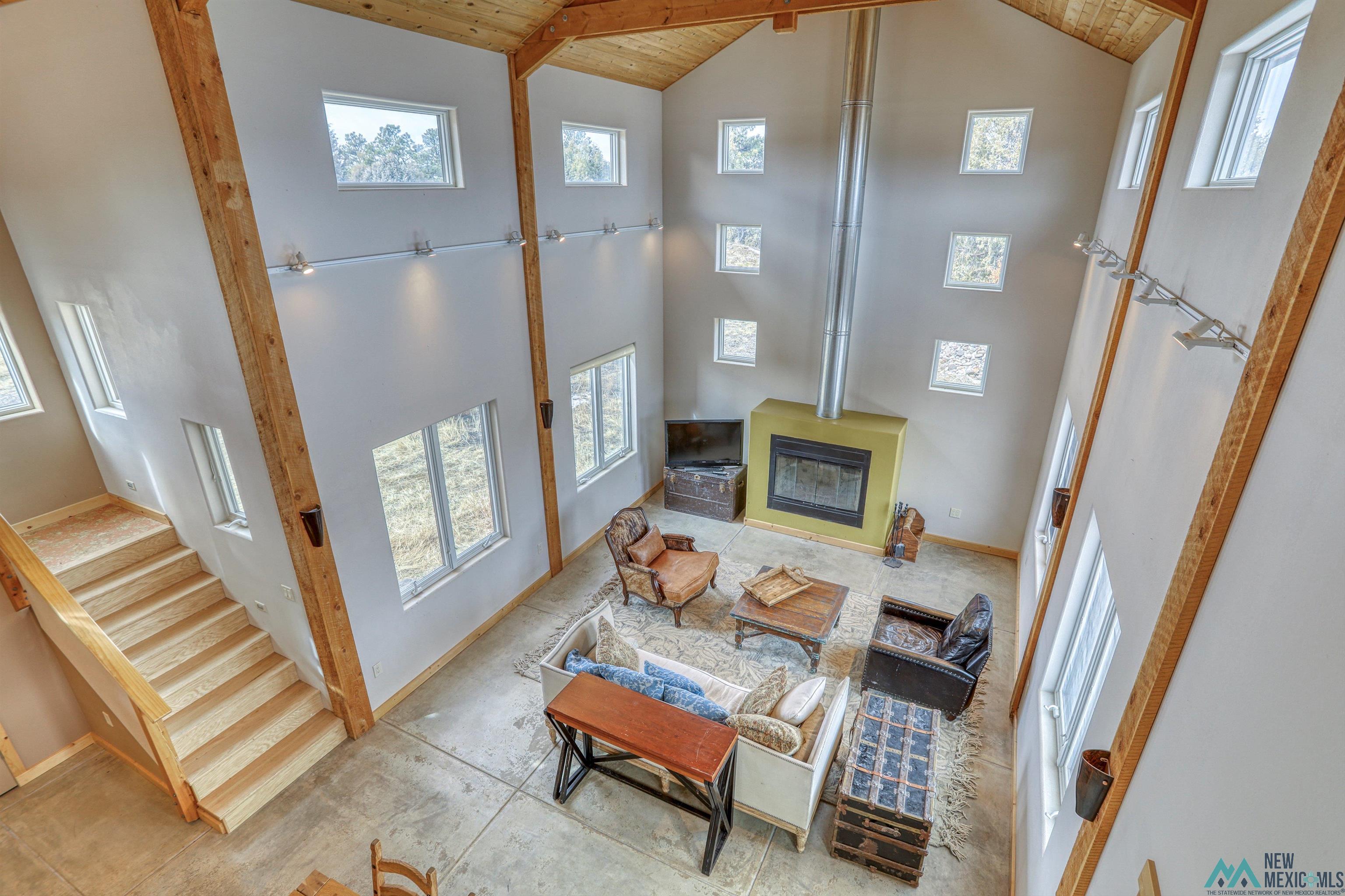 12 Horn Toad Road Chama, NM 87520 - Photo 44 of 52 Living area featuring high vaulted ceiling and a wood ceiling with exposed beams