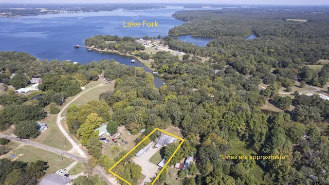 an aerial view of a house with a yard