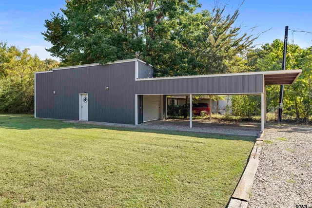 a view of a house with backyard porch and sitting area