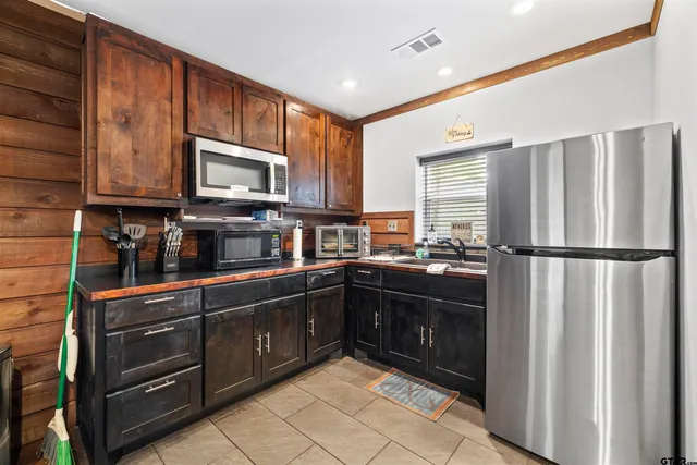 a kitchen with stainless steel appliances granite countertop a refrigerator stove and microwave