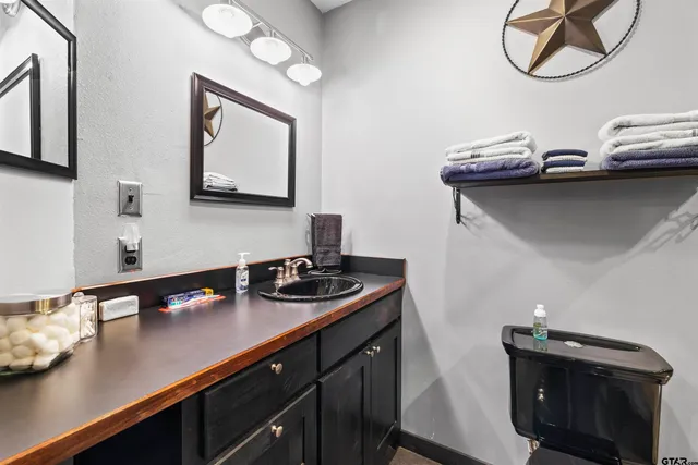a kitchen with a sink cabinets and a wooden floor