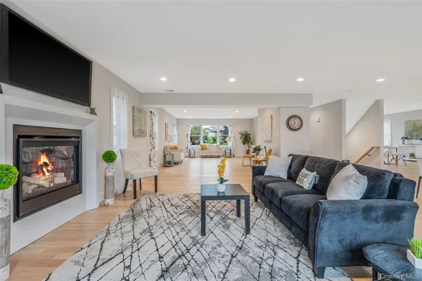 a living room with furniture a fireplace and a flat screen tv