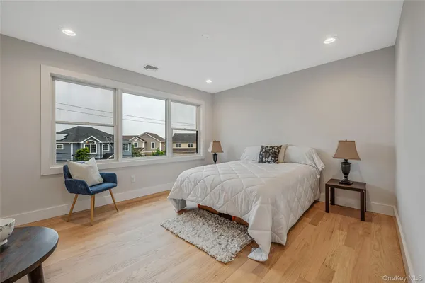 a spacious bedroom with a bed and a couch