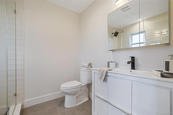 a bathroom with a toilet sink and vanity