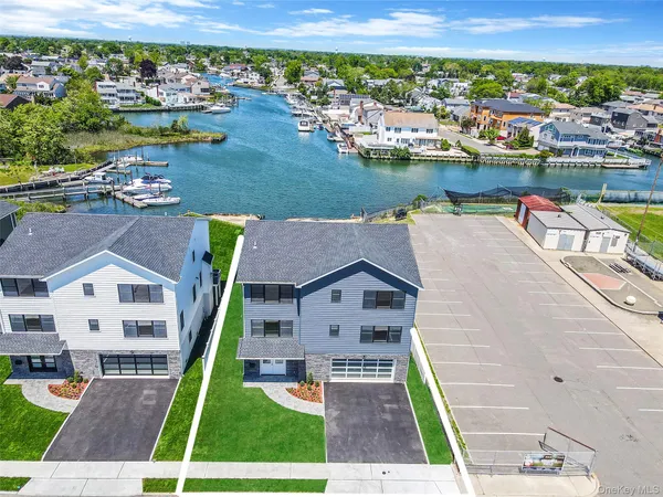 an aerial view of a house with a garden and lake view