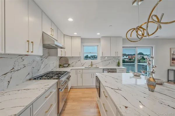 a kitchen with stainless steel appliances granite countertop a sink and cabinets