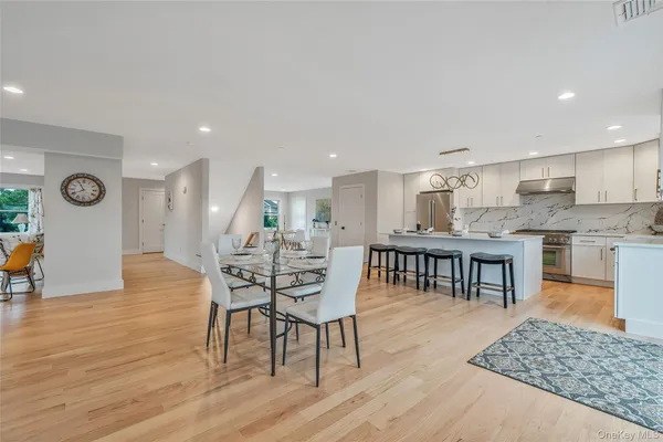 a dining room with furniture and wooden floor