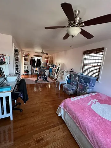 a bed room with a bed mirror and a ceiling fan