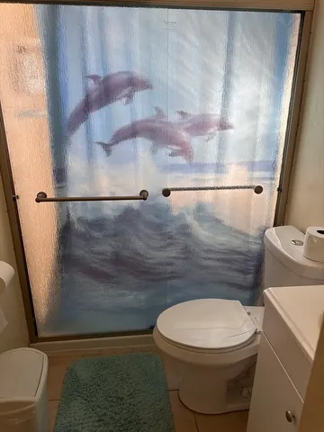 a bathroom with a toilet and a shower