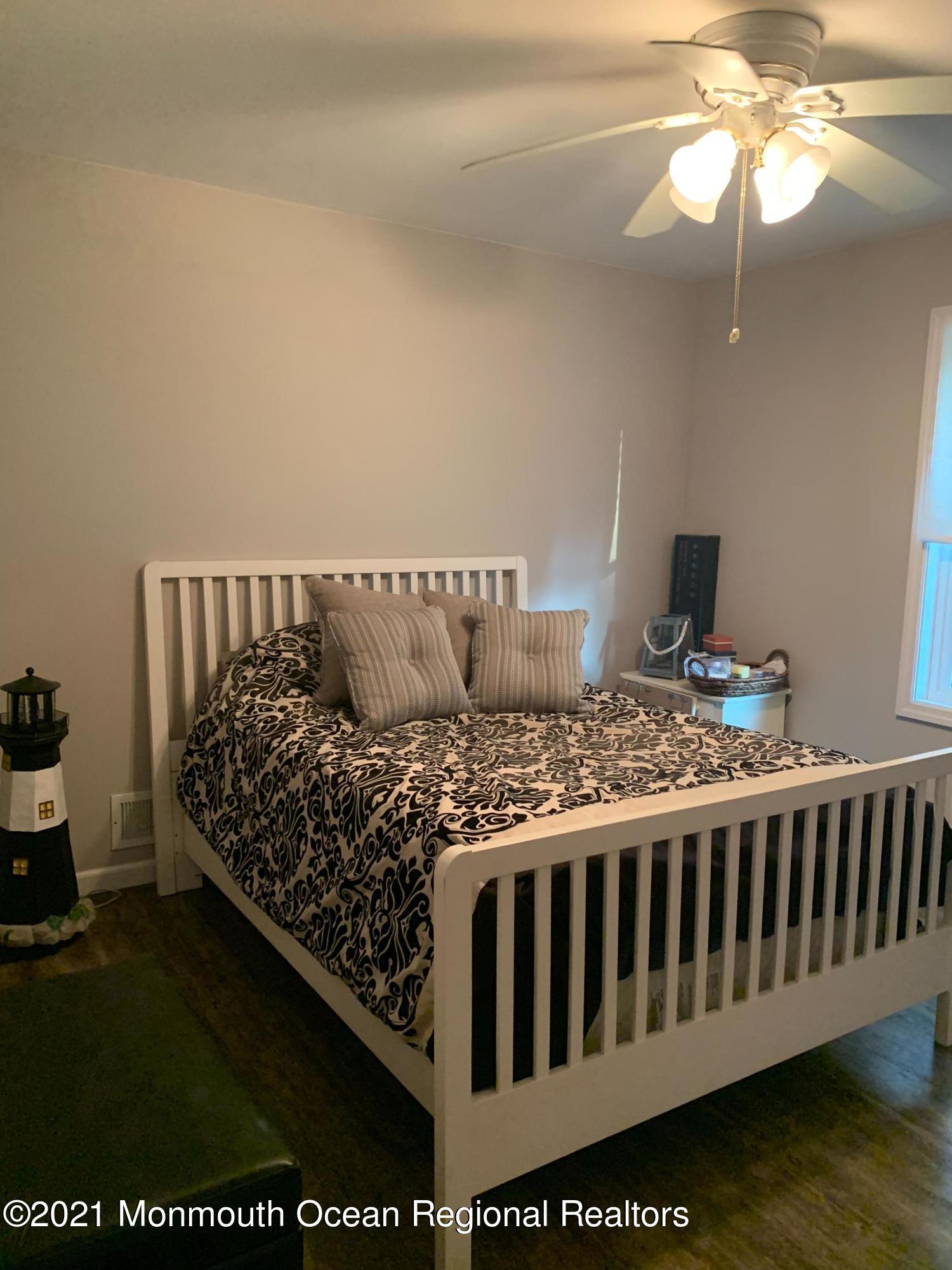836 Wright Debow Road Jackson, NJ 08527 - Photo 11 of 22 a bed sitting in a bedroom next to a window