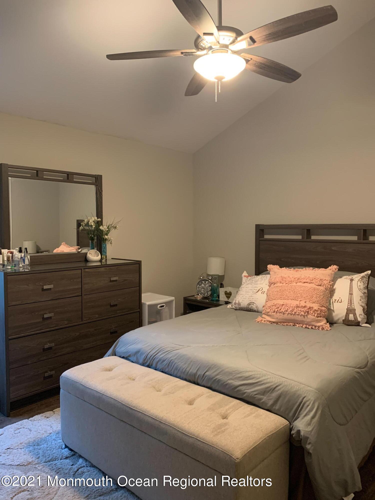 836 Wright Debow Road Jackson, NJ 08527 - Photo 16 of 22 a bedroom with a bed and a chandelier
