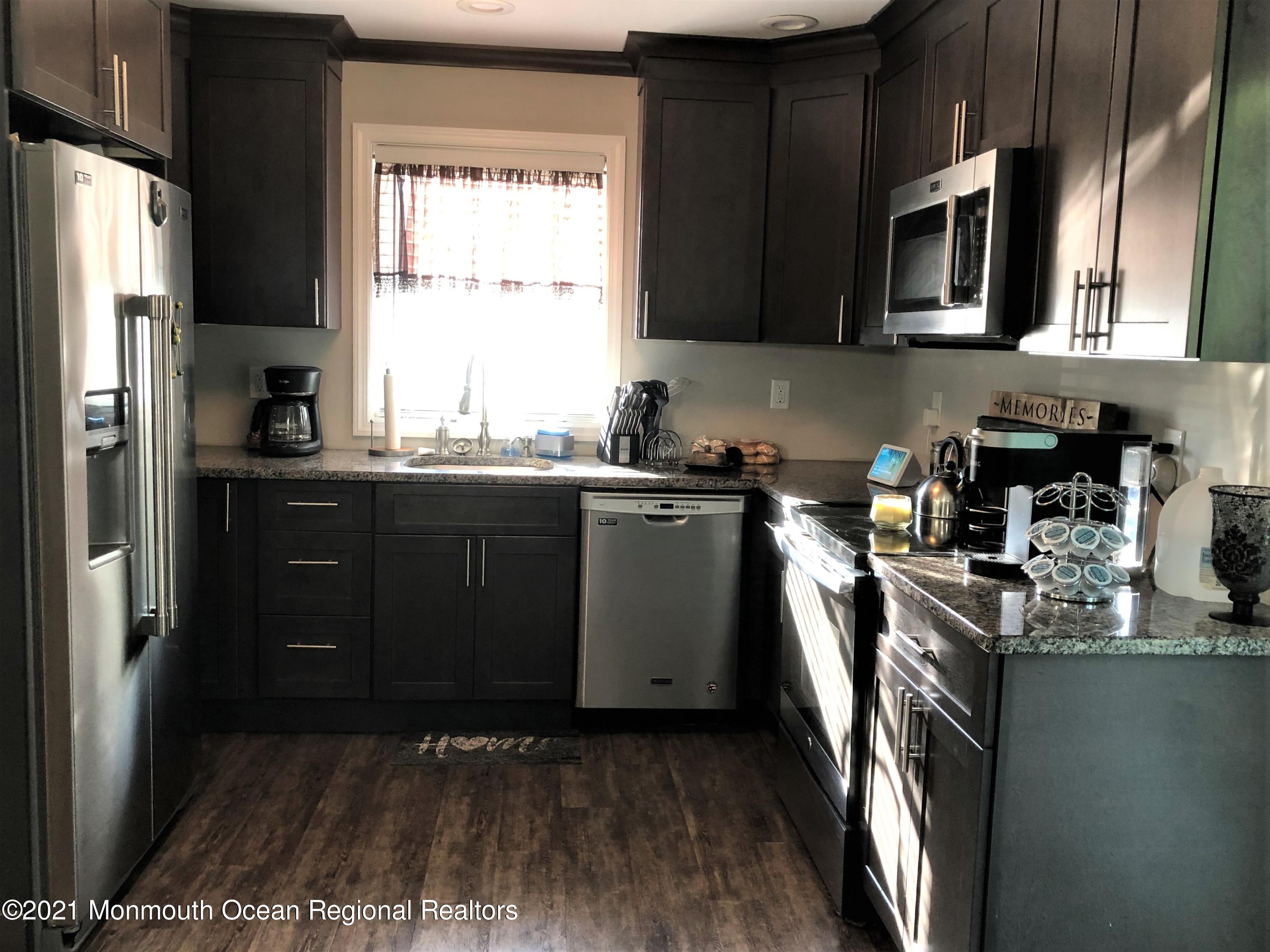 836 Wright Debow Road Jackson, NJ 08527 - Photo 6 of 22 a kitchen with stainless steel appliances granite countertop a sink a stove a refrigerator a microwave oven and cabinets