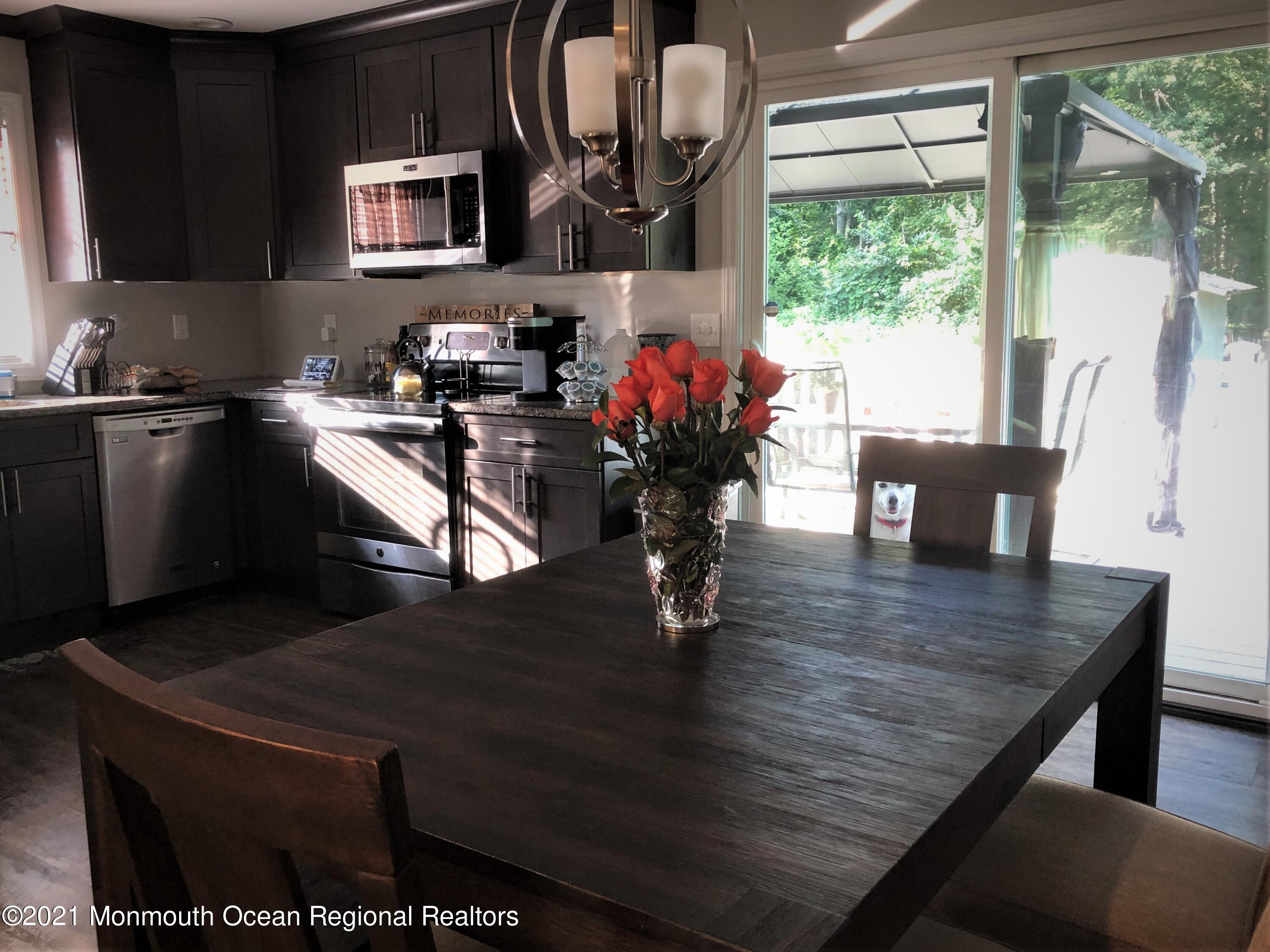 836 Wright Debow Road Jackson, NJ 08527 - Photo 7 of 22 a kitchen with a table chairs and a wooden floor