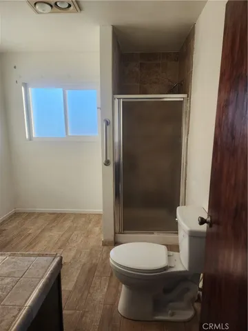 a bathroom with a toilet and a shower