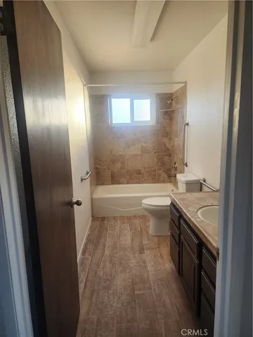 a bathroom with a sink a toilet a tub and shower