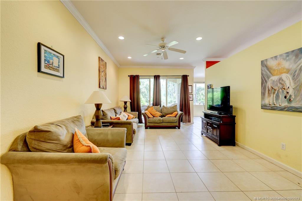316 Southwest Otter Run Place Stuart, FL 34997 - Photo 11 of 50 a living room with furniture and a flat screen tv