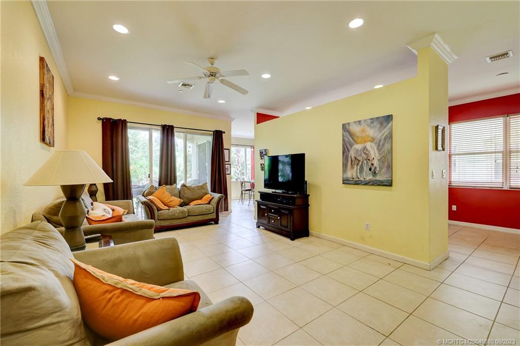 316 Southwest Otter Run Place Stuart, FL 34997 - Photo 12 of 50 a living room with furniture and a flat screen tv